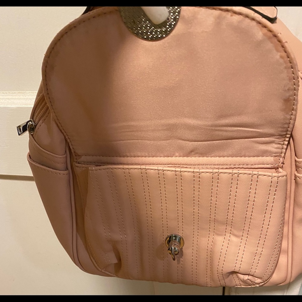 I am selling a brand new cute little purse/ backpack. Blush color